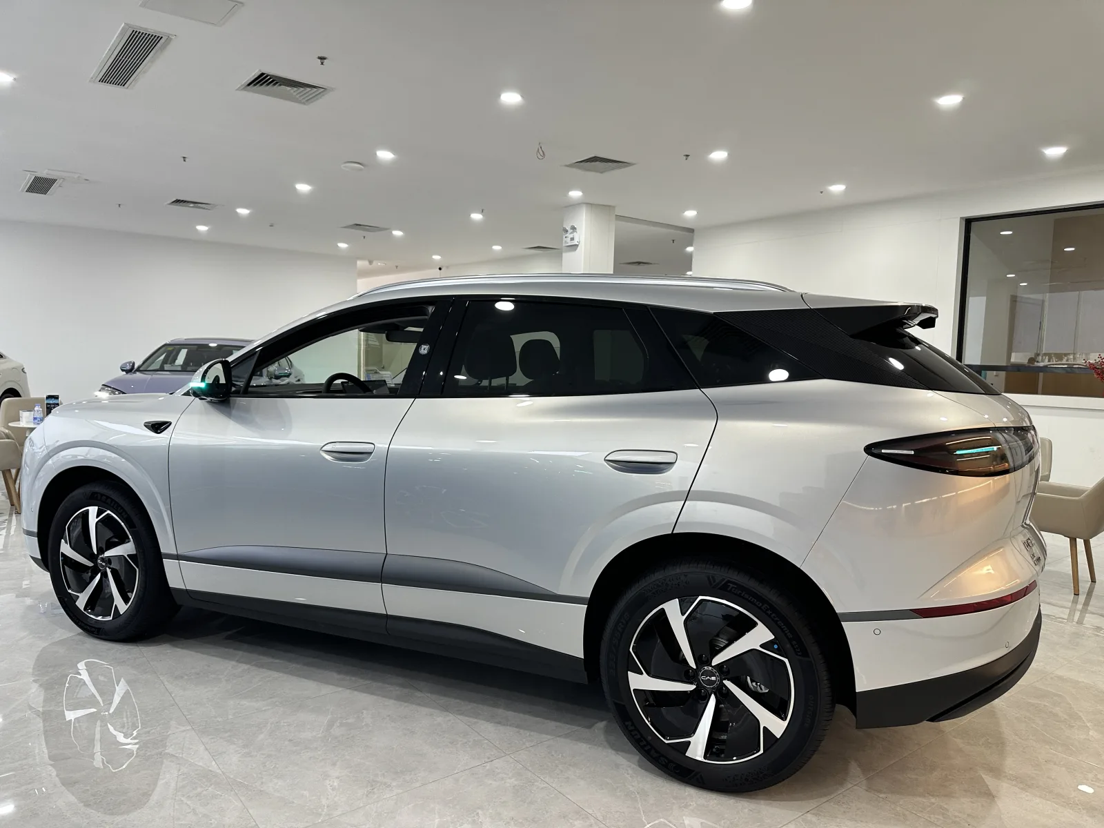 BYD Sea Lion 06 EV side profile in a vehicle showroom
